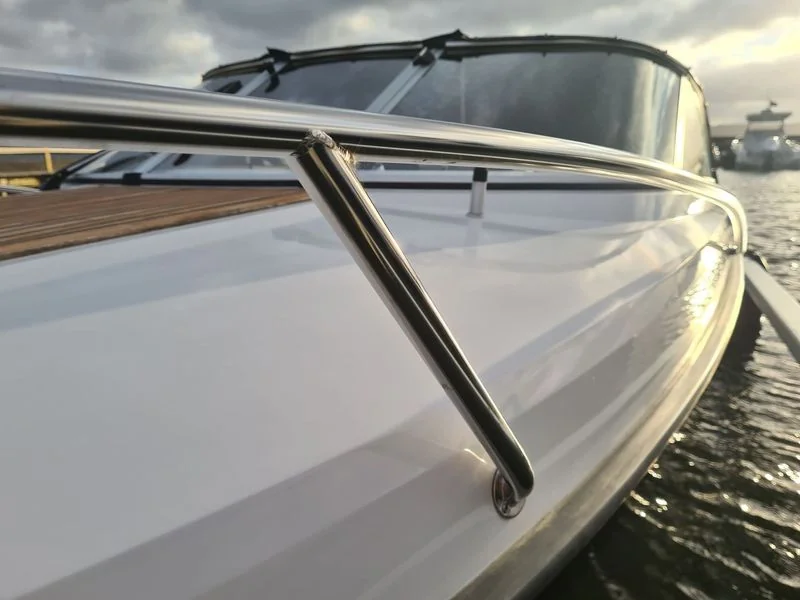 Fiberglass boat railing and windshield detail docked at Jacksonville waterfront.