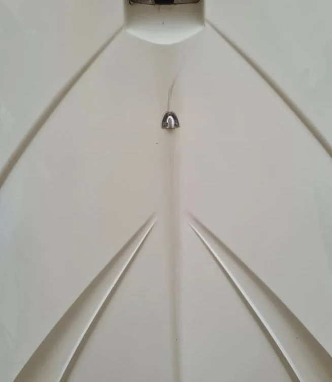Interior fiberglass boat hull showing antenna mount and structural ribs during inspection.