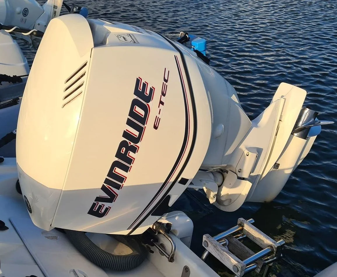 Evinrude outboard engine mounted on boat transom at dockside in Jacksonville waters.