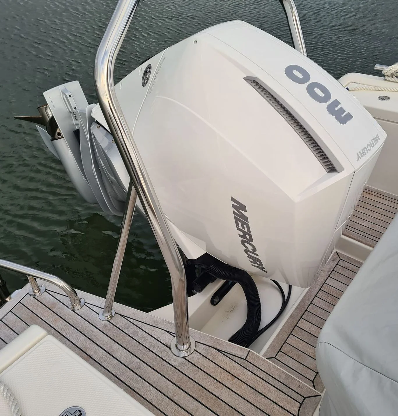 Outboard engine mounted on boat transom at Jacksonville dock, ready for service inspection.