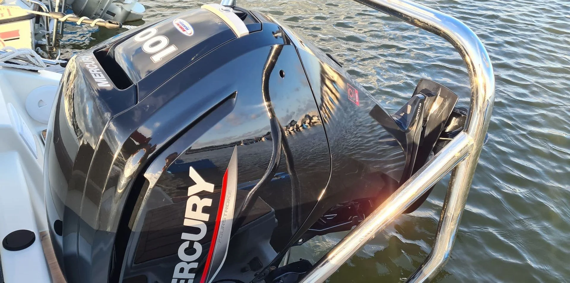 Outboard engine mounted on boat transom dockside in Jacksonville, showing mechanical components and water setting.